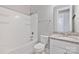 Bathroom with granite countertops, a shower/tub combo, toilet and linen shelving at 704 Kenway Loop, Mooresville, NC 28117