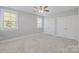 Bedroom with carpet, neutral walls, two windows, and a double door closet at 704 Kenway Loop, Mooresville, NC 28117