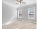 Bright and spacious bedroom with neutral carpet, crown molding, and two large windows at 704 Kenway Loop, Mooresville, NC 28117