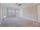 Spacious bedroom featuring neutral walls, carpet flooring, and a ceiling fan at 704 Kenway Loop, Mooresville, NC 28117