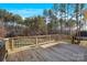 A spacious wooden deck overlooks a private, wooded backyard offering outdoor living and scenic views at 704 Kenway Loop, Mooresville, NC 28117
