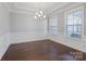 Formal dining room featuring elegant lighting, neutral decor, and hardwood floors at 704 Kenway Loop, Mooresville, NC 28117