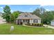Charming one-and-a-half-story home with manicured lawn and stone accents at 704 Kenway Loop, Mooresville, NC 28117