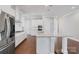 Close up of kitchen with white cabinets, stainless steel appliances, and large island with granite countertop at 704 Kenway Loop, Mooresville, NC 28117