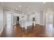 Bright kitchen features white cabinets, stainless steel appliances, and a large island with bar seating at 704 Kenway Loop, Mooresville, NC 28117