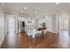 Bright kitchen features white cabinets, stainless steel appliances, and a large island with bar seating at 704 Kenway Loop, Mooresville, NC 28117