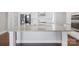 Close-up of the kitchen island featuring a granite countertop and white cabinetry at 704 Kenway Loop, Mooresville, NC 28117