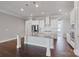 Spacious kitchen with stainless steel appliances, white cabinetry, granite countertops, and hardwood floors at 704 Kenway Loop, Mooresville, NC 28117