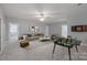 Large living room with neutral walls, ceiling fan and games at 704 Kenway Loop, Mooresville, NC 28117