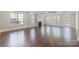 Open-concept living space with hardwood floors, recessed lighting, a fireplace, and abundant natural light at 704 Kenway Loop, Mooresville, NC 28117