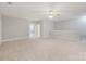 Spacious loft area with neutral walls and carpet flooring with view into next room at 704 Kenway Loop, Mooresville, NC 28117