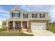 Two-story house with stone and siding, two-car garage, and landscaped lawn at 8042 Kennesaw Dr, Gastonia, NC 28056