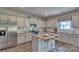 Modern kitchen with granite island, stainless steel appliances, and hardwood floors at 8042 Kennesaw Dr, Gastonia, NC 28056