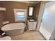 Bright bathroom featuring a freestanding tub, glass shower, and modern vanity at 913 9Th Ne Ave, Hickory, NC 28601