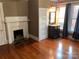 Hardwood floors and a fireplace accent this cozy bedroom at 913 9Th Ne Ave, Hickory, NC 28601