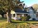 Charming home with a welcoming front porch, lush landscaping, and a mature tree providing shade and character at 913 9Th Ne Ave, Hickory, NC 28601