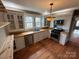 Updated kitchen boasts wood floors, white cabinets, and stainless steel appliances at 913 9Th Ne Ave, Hickory, NC 28601