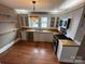 Bright kitchen features wood floors, white cabinets, and stainless steel appliances at 913 9Th Ne Ave, Hickory, NC 28601