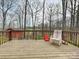 Back deck with seating looks out into a wooded backyard at 1008 E Sandy Ridge Rd, Monroe, NC 28112