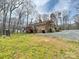 Back of brick home with a deck overlooking a spacious backyard at 1008 E Sandy Ridge Rd, Monroe, NC 28112