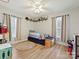 A cozy ' bedroom features wood-look floors, natural light, and fun decorative shelves at 1008 E Sandy Ridge Rd, Monroe, NC 28112