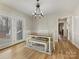 Bright dining room features a modern chandelier and access to the outdoors through French doors at 1008 E Sandy Ridge Rd, Monroe, NC 28112