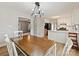 Bright dining area adjacent to the kitchen, featuring a modern chandelier and hardwood floors at 1008 E Sandy Ridge Rd, Monroe, NC 28112