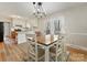 Stylish dining area with a rustic table, modern lighting, and access to the backyard through glass doors at 1008 E Sandy Ridge Rd, Monroe, NC 28112