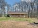 Charming brick ranch home featuring a cozy front porch and beautiful natural surroundings at 1008 E Sandy Ridge Rd, Monroe, NC 28112