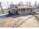 Brick ranch house with covered porch and mature trees, offering curb appeal at 1008 E Sandy Ridge Rd, Monroe, NC 28112