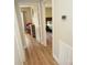 Hallway leading to bedrooms with hardwood style floors and neutral paint palette at 1008 E Sandy Ridge Rd, Monroe, NC 28112