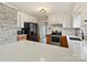 Bright kitchen features white cabinets, stainless steel appliances, and a beautiful brick accent wall at 1008 E Sandy Ridge Rd, Monroe, NC 28112