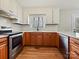 This bright kitchen boasts stainless appliances, white subway tile backsplash, and wood-look floors at 1008 E Sandy Ridge Rd, Monroe, NC 28112