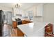 Bright kitchen with white cabinets, stainless steel appliances, and a breakfast bar at 1008 E Sandy Ridge Rd, Monroe, NC 28112