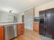 This kitchen features stainless appliances, a white brick accent wall and wood look floors at 1008 E Sandy Ridge Rd, Monroe, NC 28112