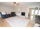 Light-filled living room featuring hardwood floors, a fireplace, and built-in shelving at 1008 E Sandy Ridge Rd, Monroe, NC 28112