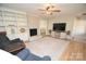 Spacious living room with hardwood floors, a fireplace and built-in shelving at 1008 E Sandy Ridge Rd, Monroe, NC 28112