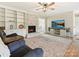 Cozy living room featuring a fireplace, built-in shelving, and a TV for entertaining guests at 1008 E Sandy Ridge Rd, Monroe, NC 28112