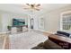 Open living space with hardwood floors, a TV, and an inviting view from the front door at 1008 E Sandy Ridge Rd, Monroe, NC 28112