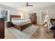 Spacious main bedroom features a ceiling fan, wood-look floors, and large windows for natural light at 1008 E Sandy Ridge Rd, Monroe, NC 28112