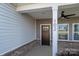 Front entrance with dark brown door and a covered porch at 102 Lake George Dr, Shelby, NC 28152