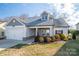 Two-story house with gray siding, white garage door, and landscaping at 102 Lake George Dr, Shelby, NC 28152