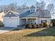 Two-story house with gray siding, white garage door, and landscaping at 102 Lake George Dr, Shelby, NC 28152