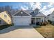 Two-story house with gray siding, white garage door, and landscaping at 102 Lake George Dr, Shelby, NC 28152