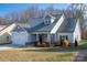 Two-story house with gray siding, white garage door, and landscaping at 102 Lake George Dr, Shelby, NC 28152