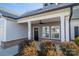 Inviting front porch with gray siding and brick accents at 102 Lake George Dr, Shelby, NC 28152