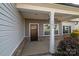 Covered front porch with dark brown door and white trim at 102 Lake George Dr, Shelby, NC 28152