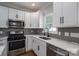 Modern kitchen with stainless steel appliances and white cabinets at 102 Lake George Dr, Shelby, NC 28152