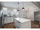 Modern kitchen with white cabinets, marble countertops, and stainless steel appliances at 102 Lake George Dr, Shelby, NC 28152