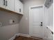 Laundry room with white cabinets and wood flooring at 102 Lake George Dr, Shelby, NC 28152